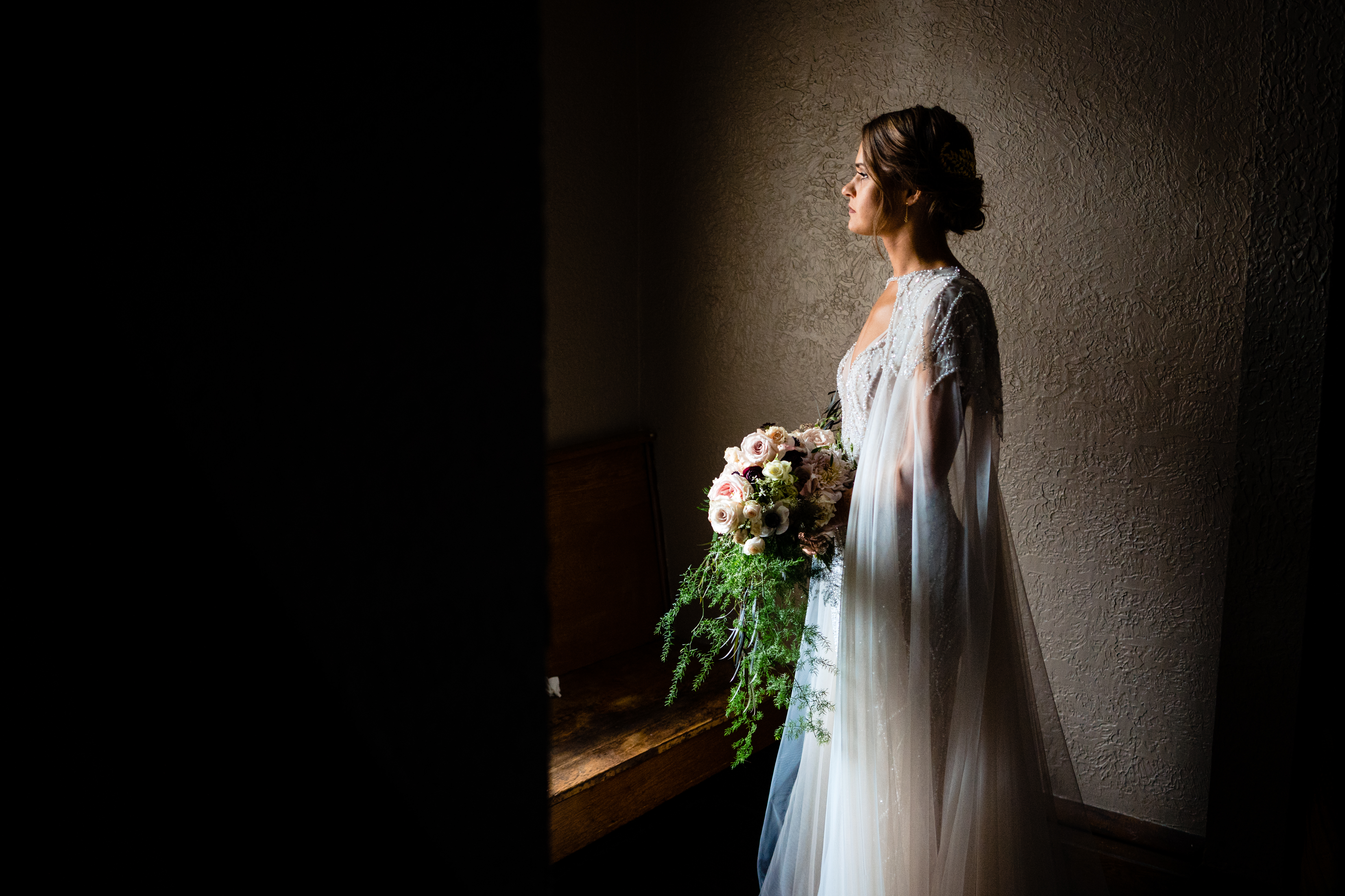 Theater wedding, no problem. At the Skylight Wedding Venue in Newark, Ohio a bride waits in window light to walk down the aisle.