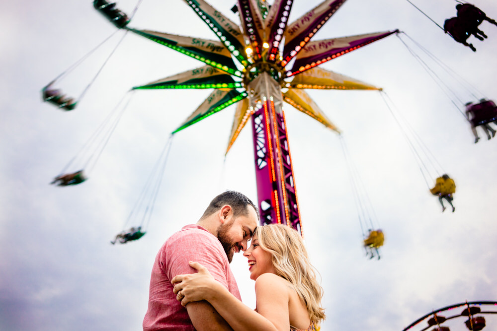 Bride and Groom laughing by the Yo-Yo ride at the Ohio State Fair