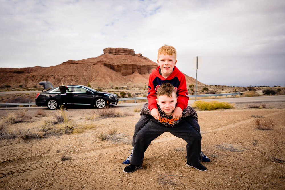 Planning your epic Utah family vacation. Two brothers play in the dirt in Moab Utah