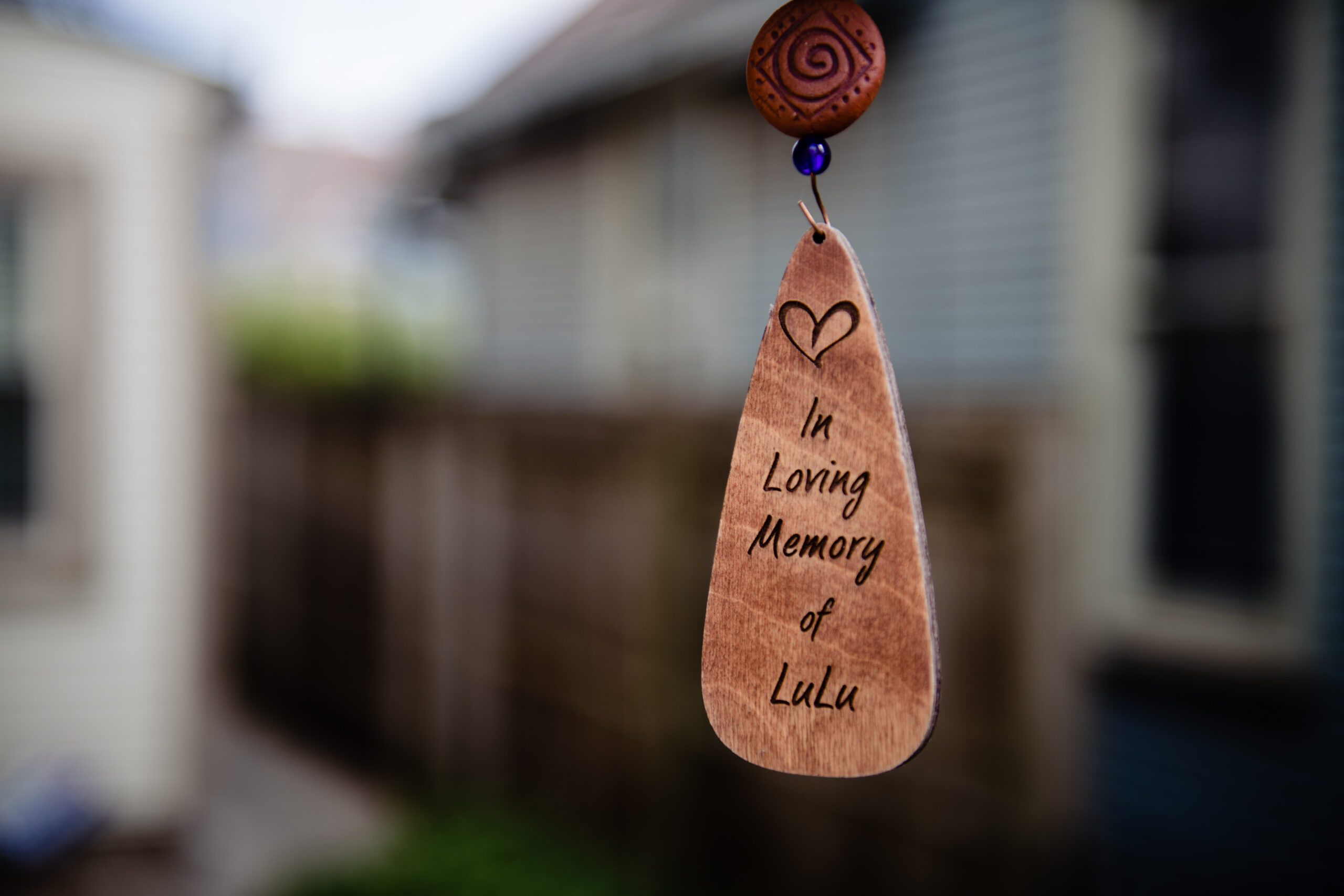 This windchime is outside of the bride and groom's Columbus, Ohio home. As it rings, Lulu the family's dog is remembered. Lulu passed away a few months prior.