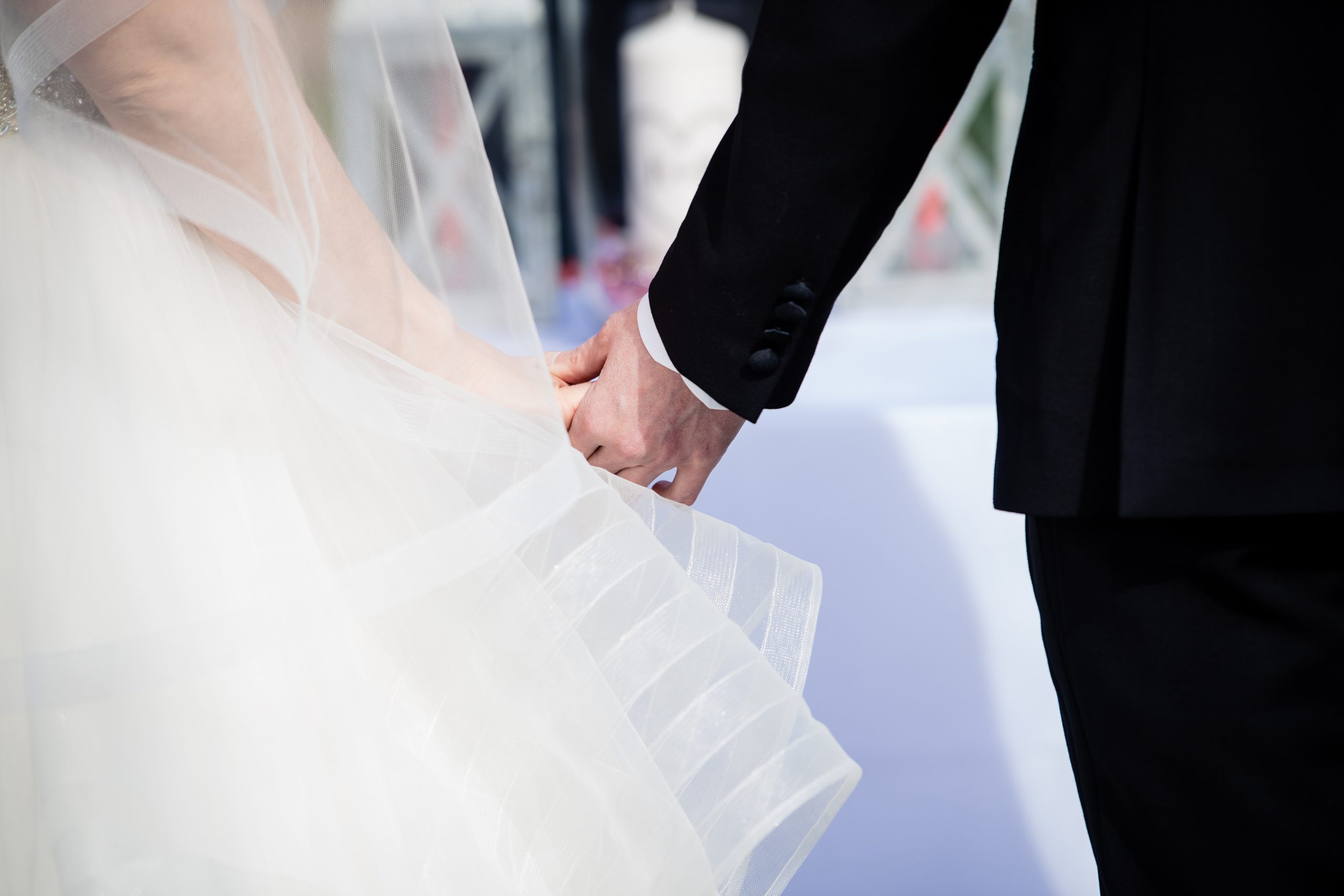 Bride and Groom hold hands during their COVID ceremony in Columbus, Ohio