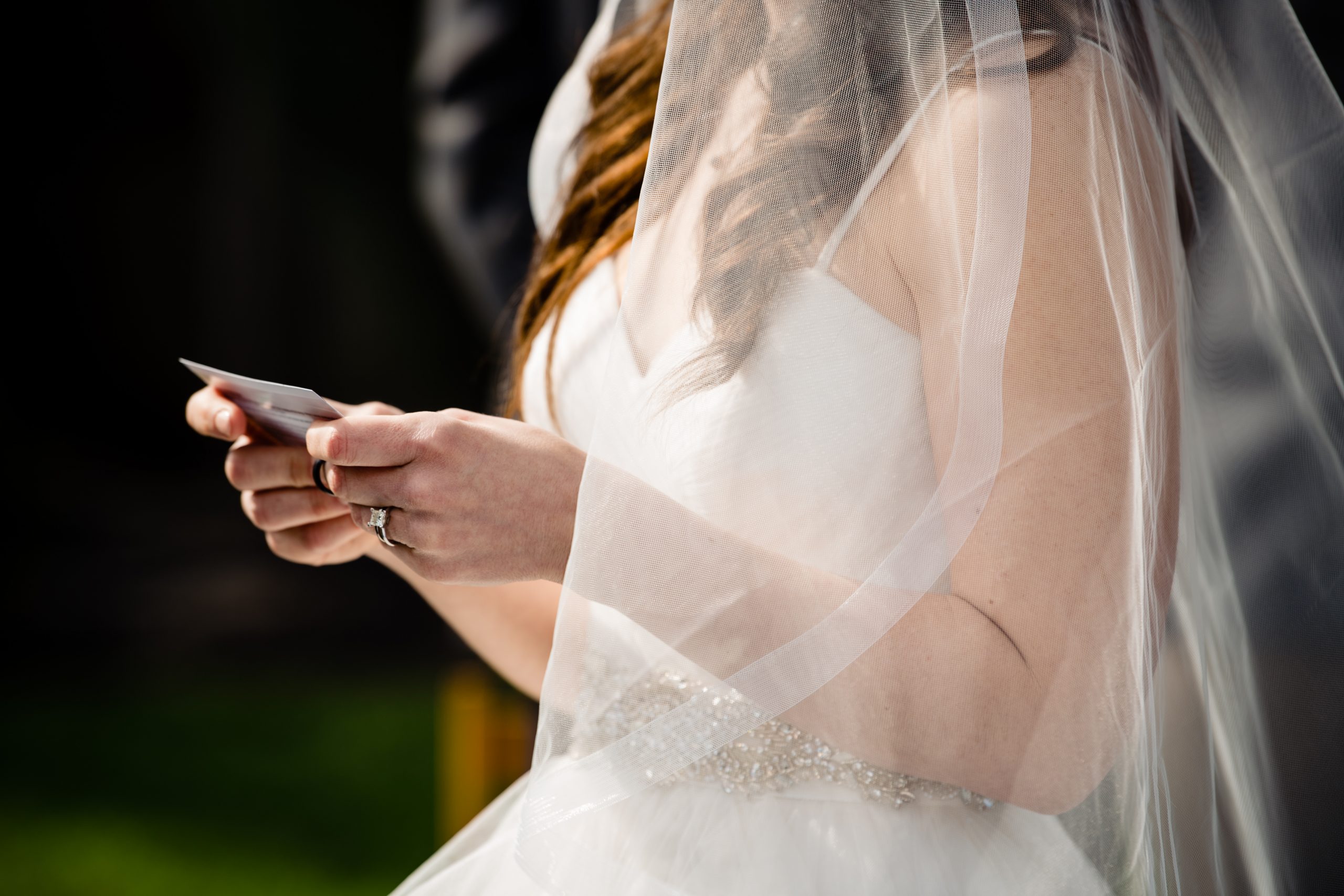 A bride reads her vows during her COVID ceremony in Columbus, Ohio