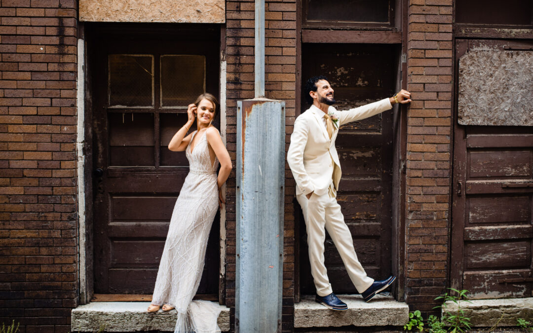 Bride and Groom stand opposite sides of wall.