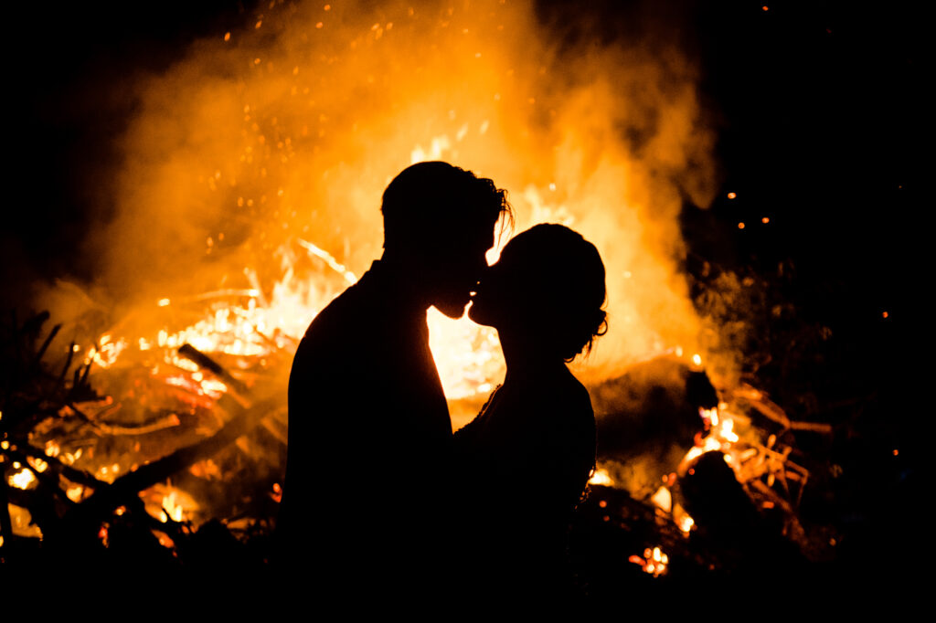 Fire behind kissing couple