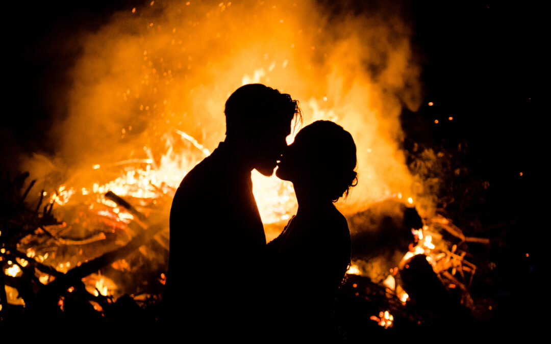 Fire behind kissing couple