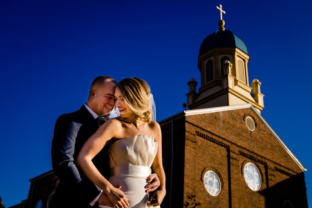 A bride and groom taking a picture at The University of Dayton