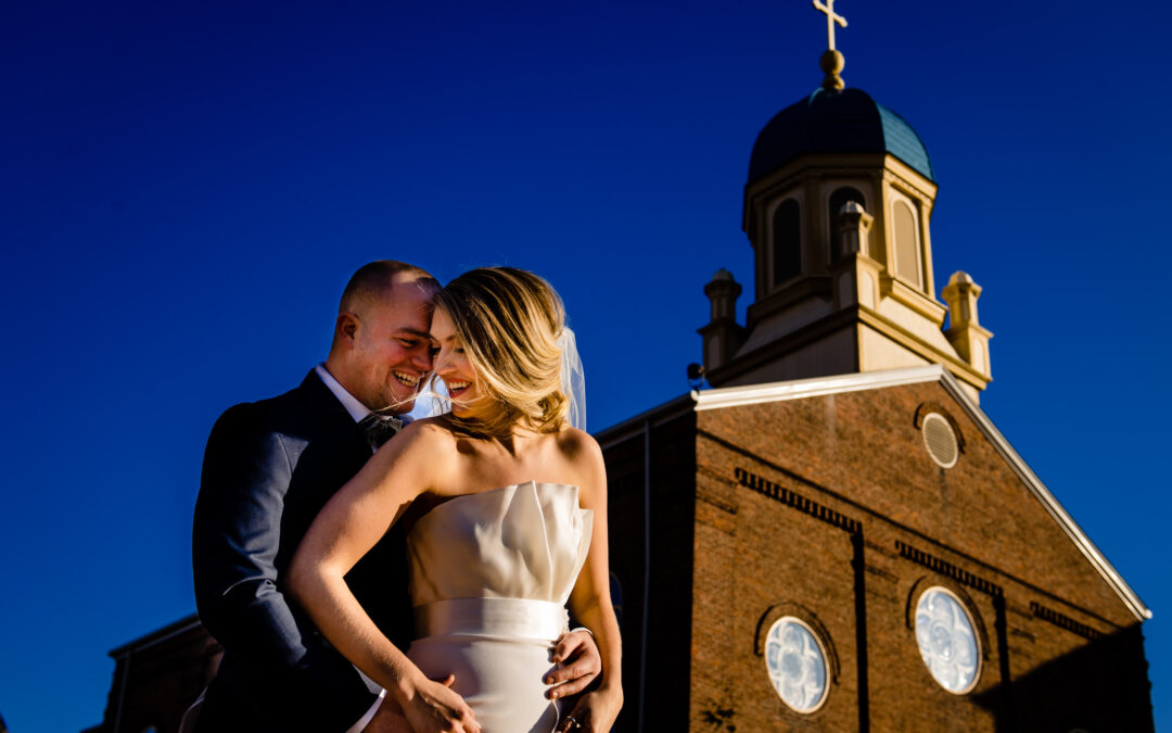 A bride and groom taking a picture at The University of Dayton