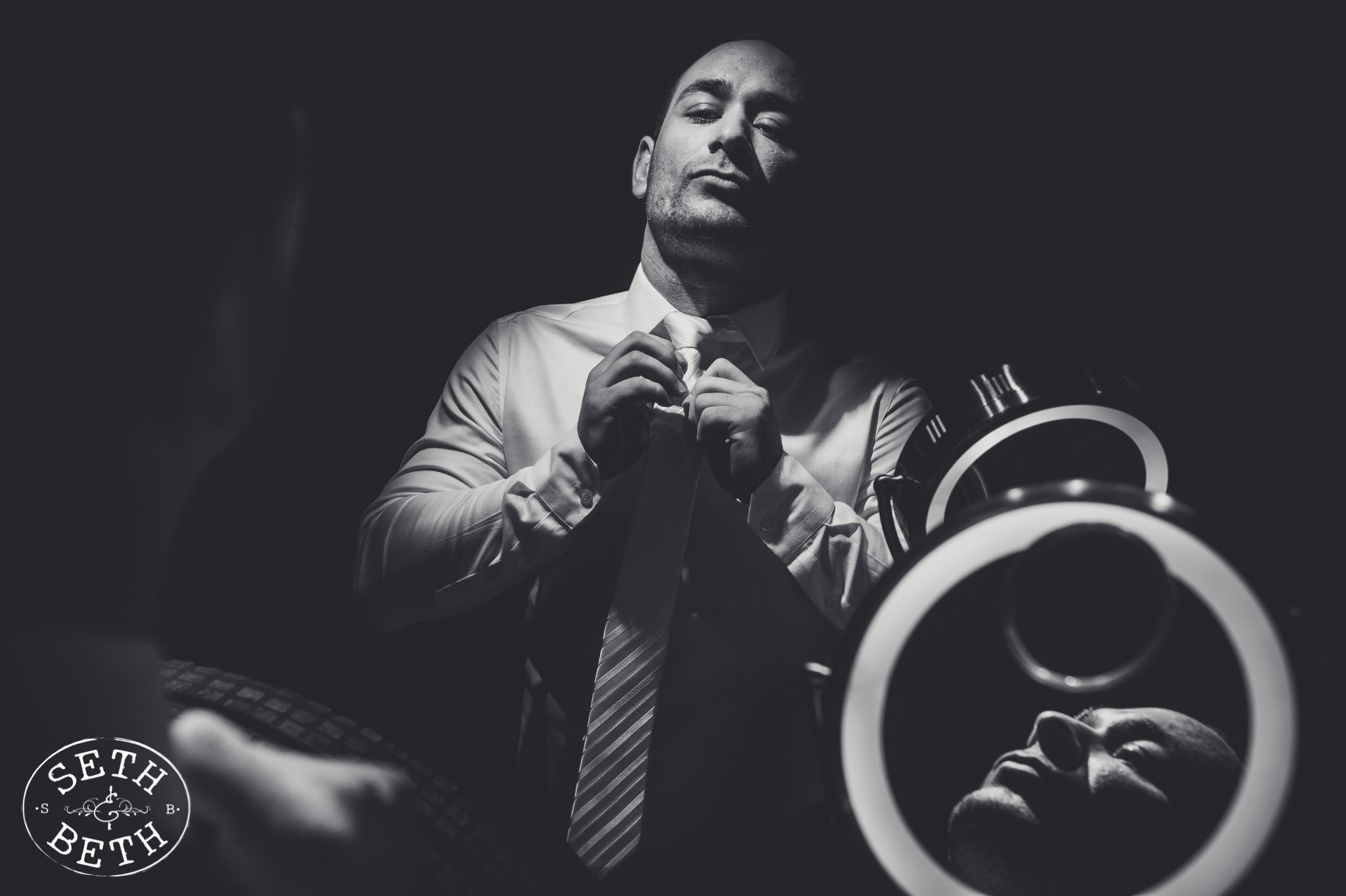 inspiring black and white photo of a groom getting ready at gervasi vineyard in canton ohio