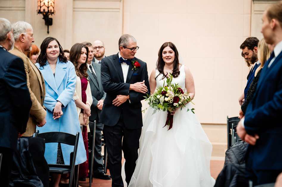 bride walking down aisle with father