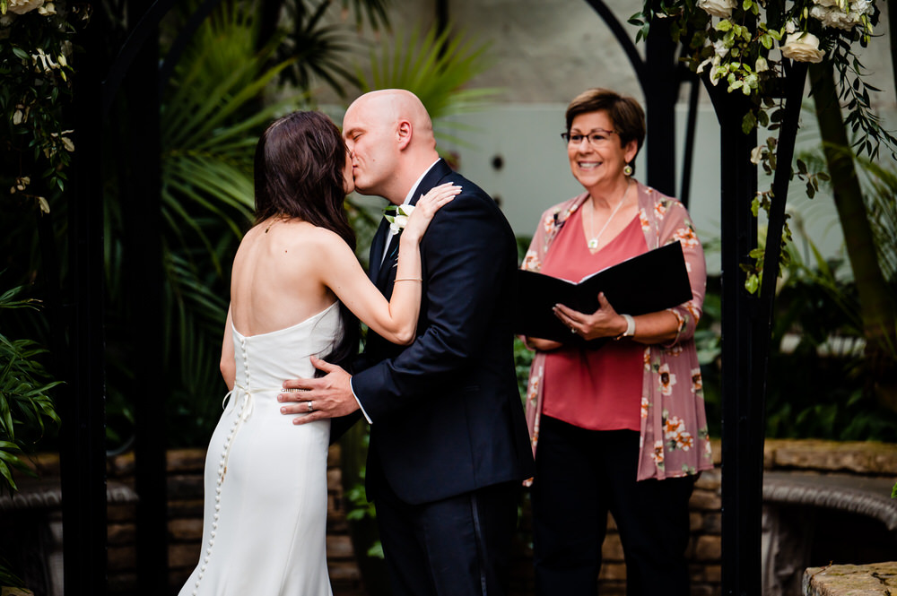 bride and groom kissing at ceremony