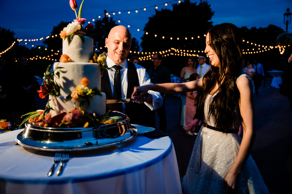 bride and groom slicing the cake