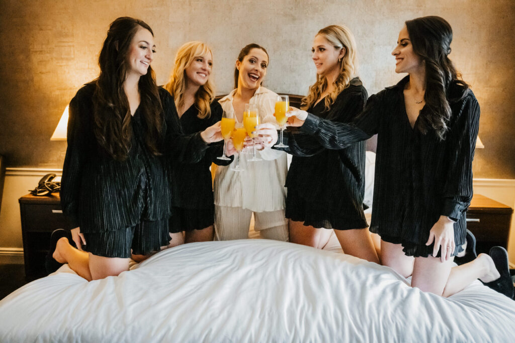 bridesmaids drinking mimosas