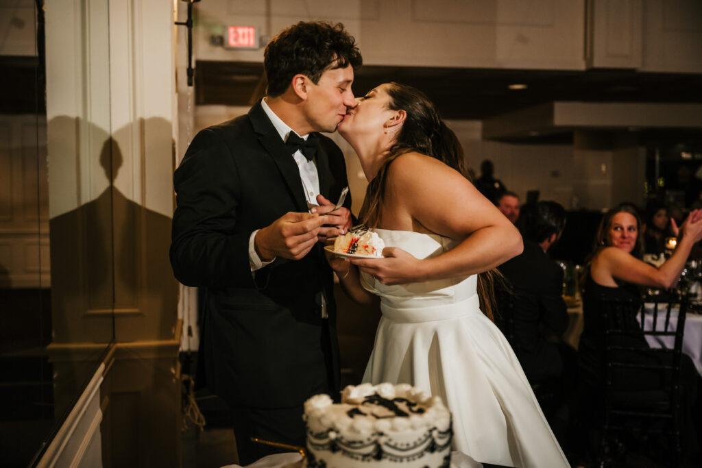 bride and groom cutting cake
