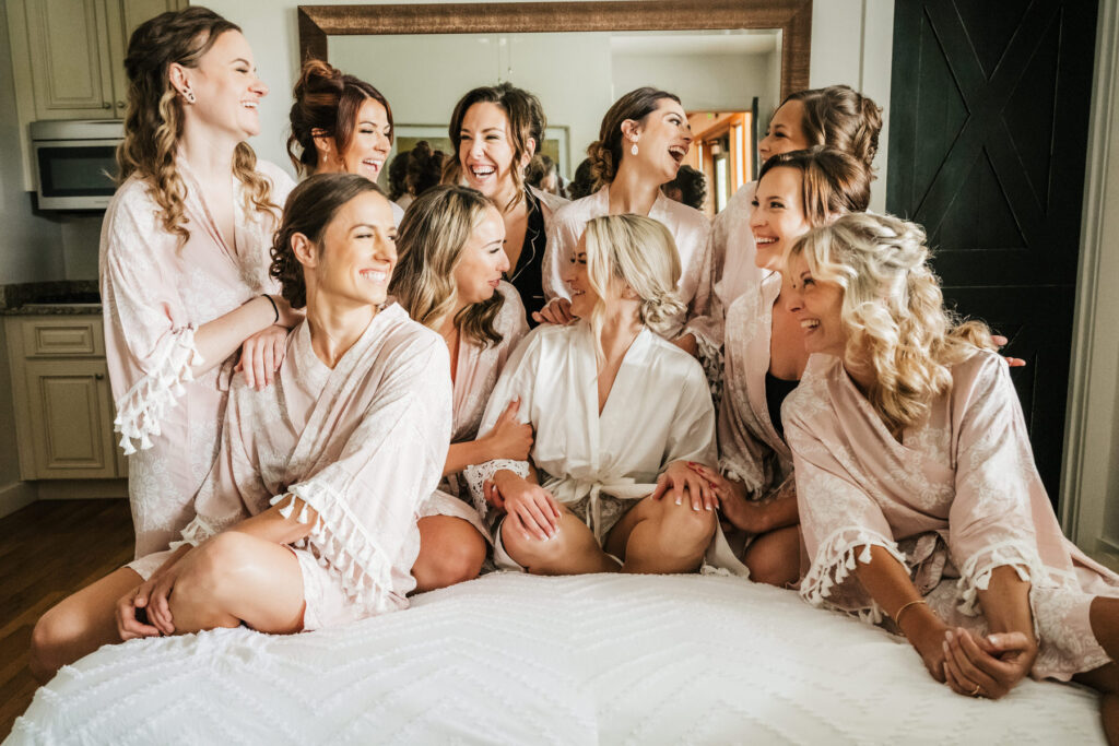 bride and bridesmaids in pajamas on the bed
