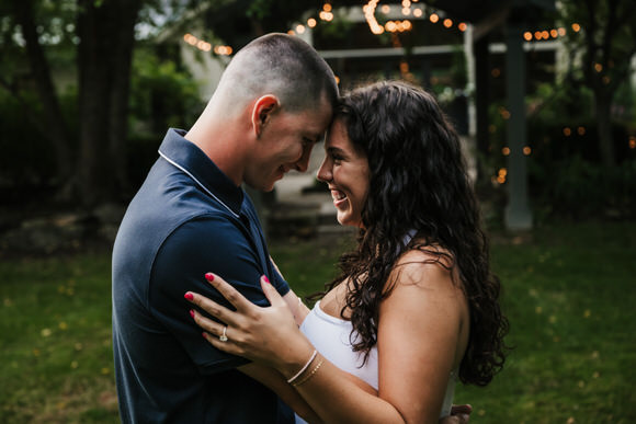 Couple embracing after a surprise winery proposal