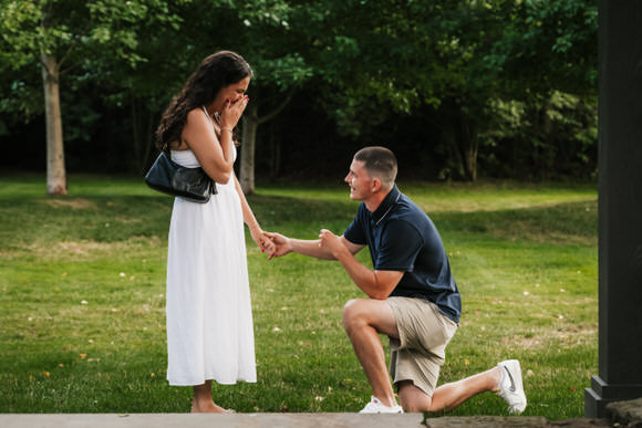 Corey down on one knee proposing at Orchard House Winery