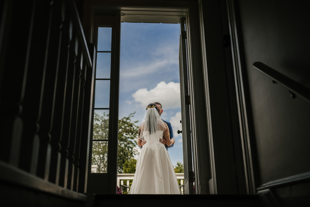 Ashley and Matt exchanging vows in the greenhouse