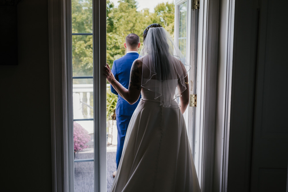 Ashley and Matt exchanging vows in the greenhouse