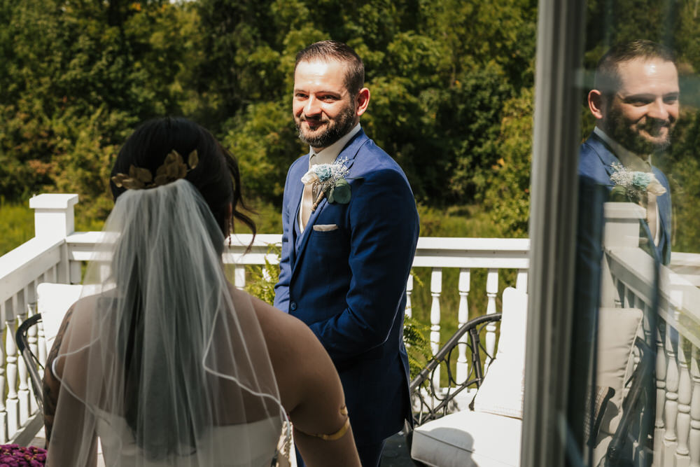 Ashley and Matt exchanging vows in the greenhouse